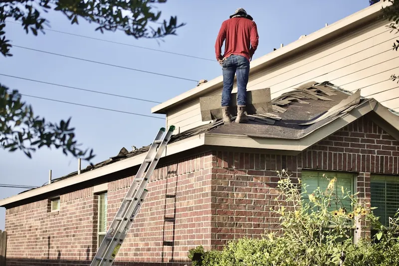 Professional roofer working on a residential roof in Regency at Monroe